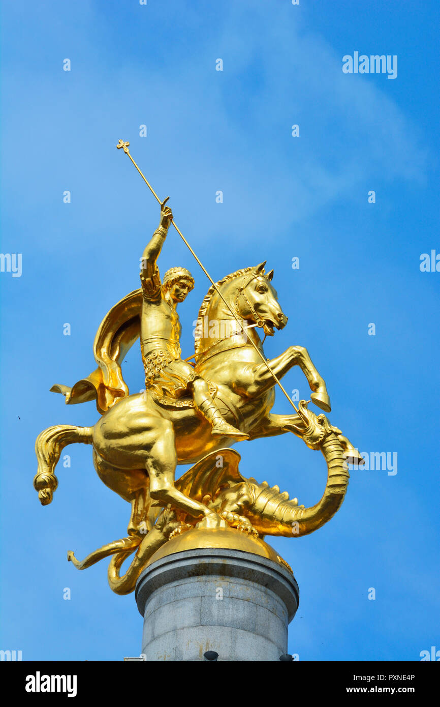 Gold covered statue of Saint and the dragon, by