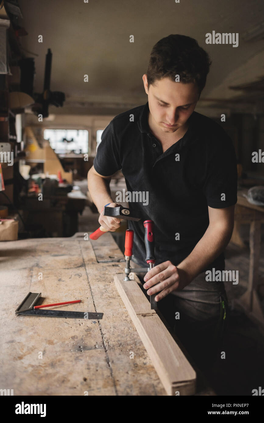 Carpenter working on piece of wood in workshop Stock Photo