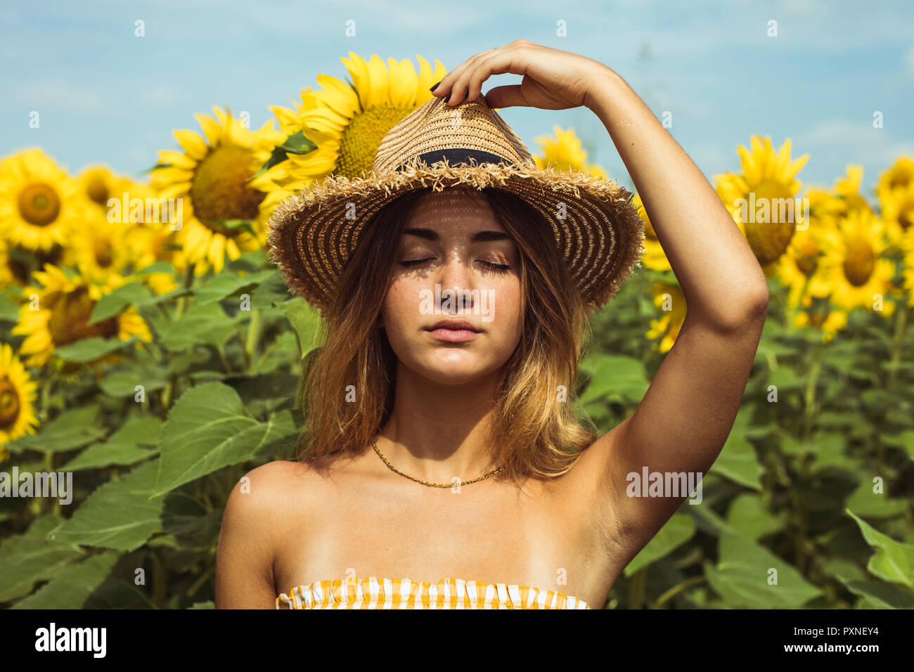 Holding straw hat on head hi-res stock photography and images - Alamy