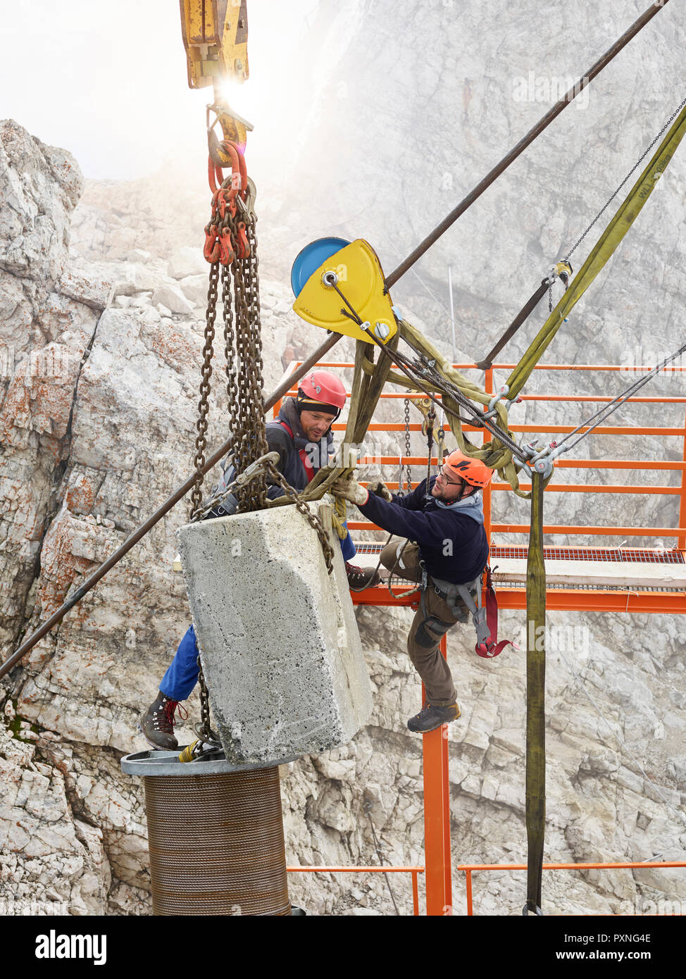 Germany, Bavaria, Garmisch-Partenkirchen, Zugspitze, installers working on goods cable lift Stock Photo