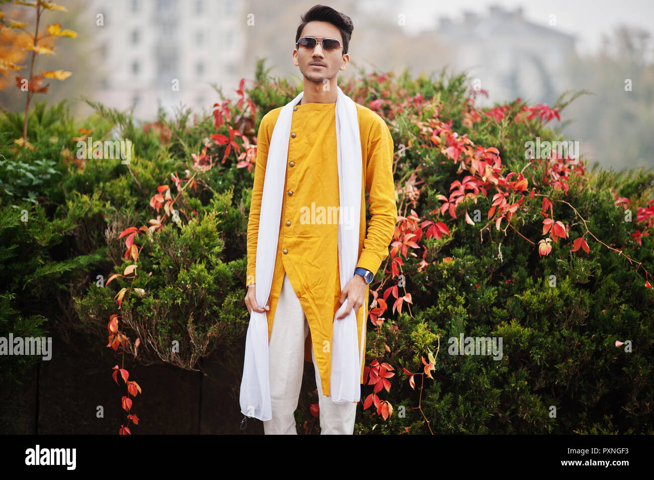 Indian stylish man in yellow traditional clothes with white scarf posed  outdoor. 10579041 Stock Photo at Vecteezy