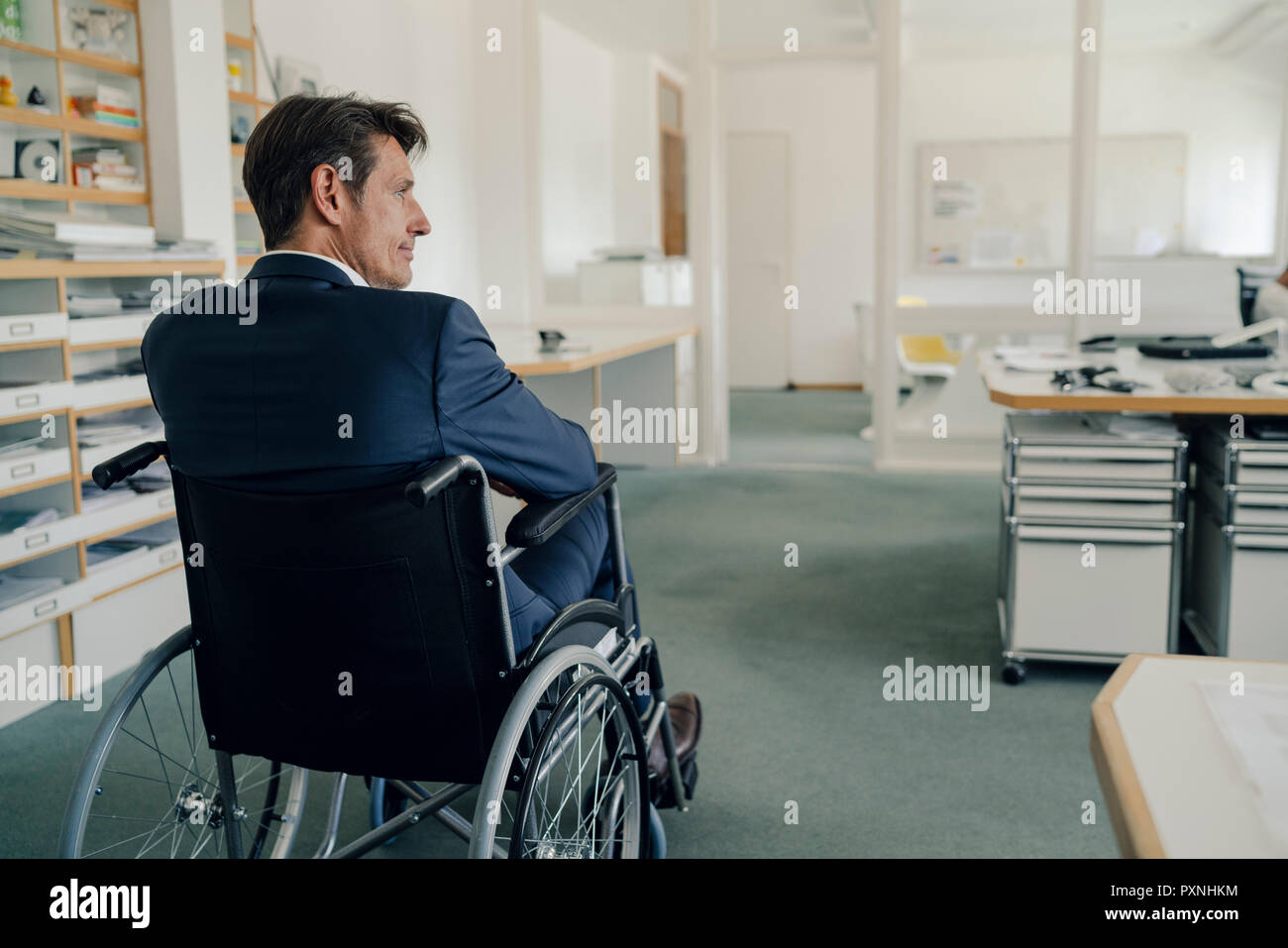 Disabled businessman sitting in wheelchair Stock Photo