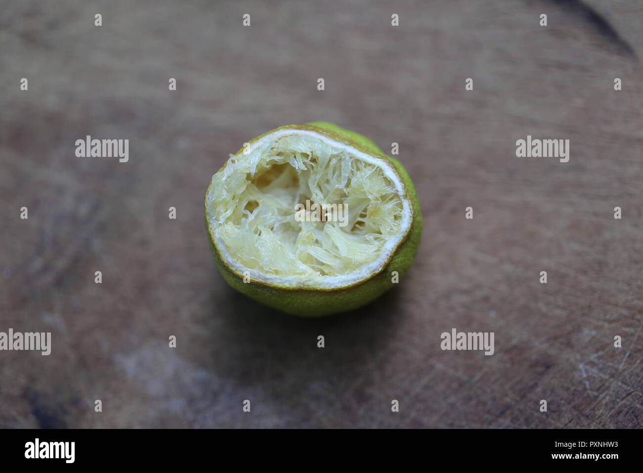 Half A Dry Lemon. Half squeezed lemon fruit, close up. Stock Photo