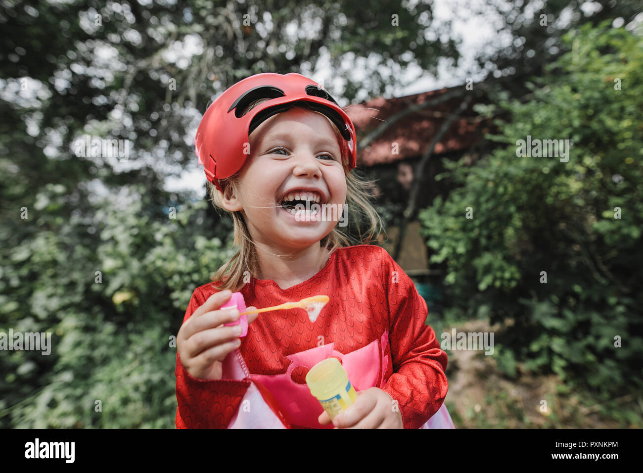 Portrait of laughing masqueraded little girl having fun Stock Photo