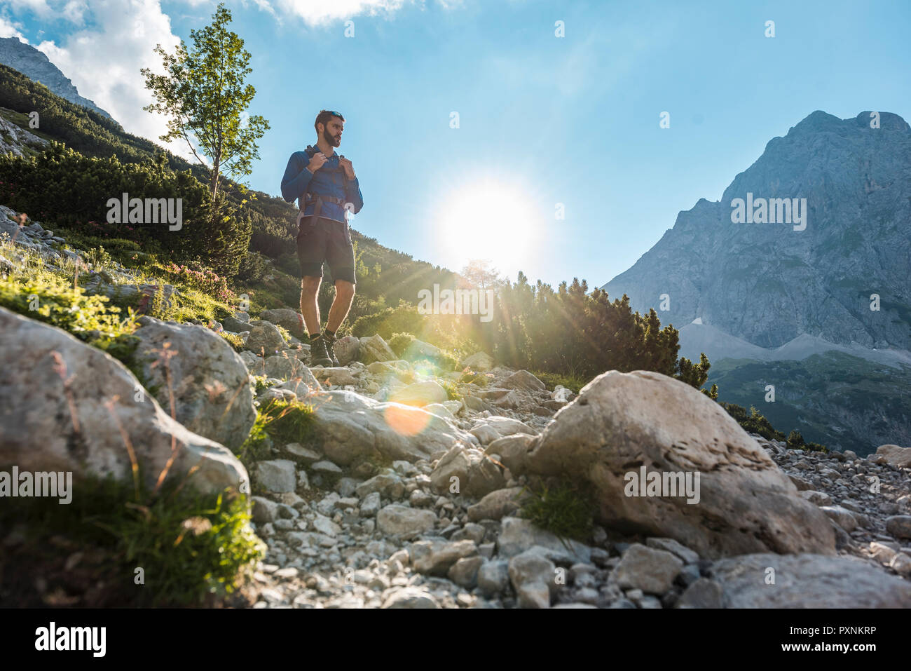 Austria, Tyrol, Young man hiking in the mountains Stock Photo