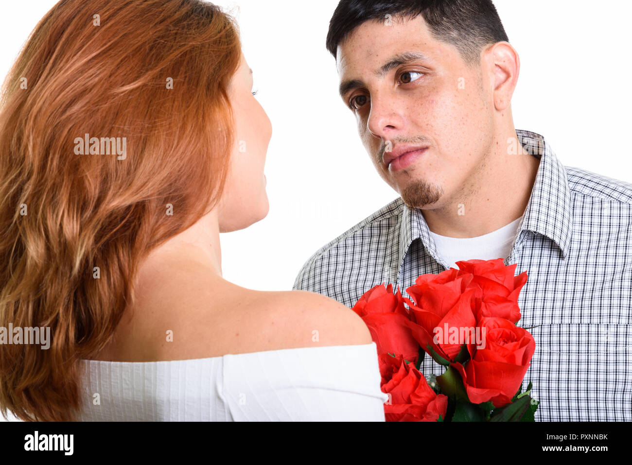 Young Hispanic couple together in love man proposing for marriage Stock Photo