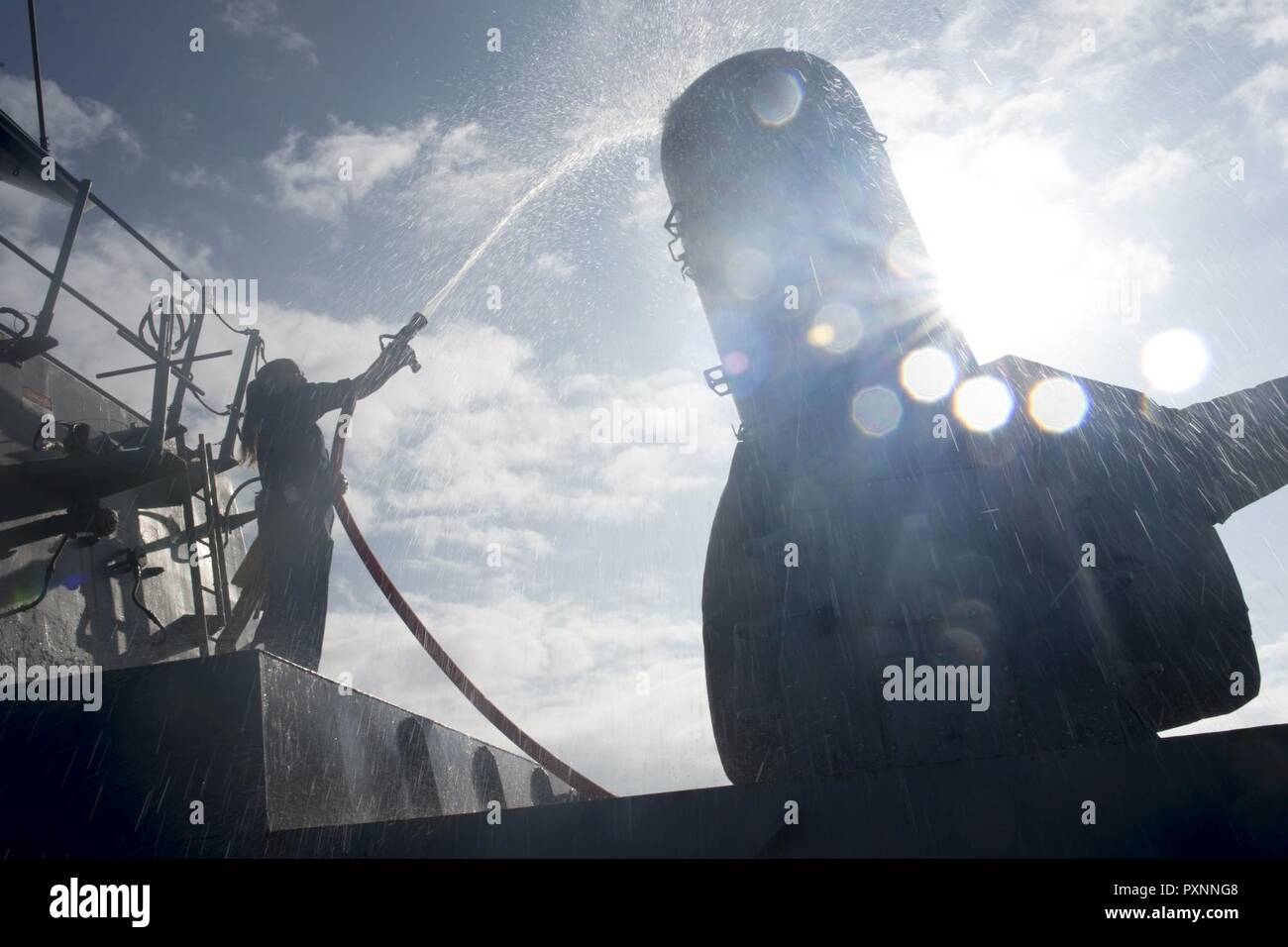 1 PACIFIC OCEAN (June 17, 2017) Fire Controlman 2nd Class Amanda Salazar, from Modesto, Calif.,  participates in a fresh-water washdown aboard the Arleigh Burke-class guided-missile destroyer USS Howard (DDG 83). Howard is currently underway as part of the Nimitz Carrier Strike Group for a regularly scheduled deployment to the Western Pacific and Indian Oceans. Stock Photo
