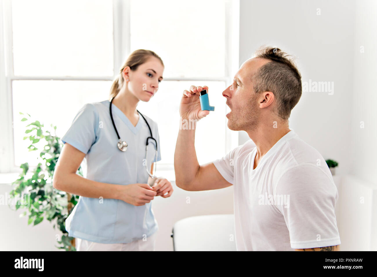 Medical doctor applying oxygen treatment on a sporty men Stock Photo Alamy