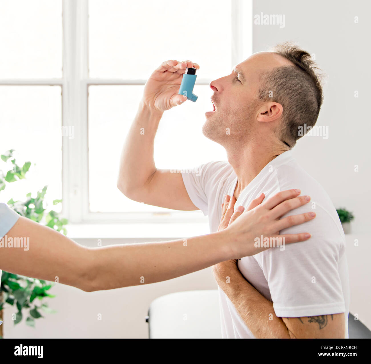 Medical doctor applying oxygen treatment on a sporty men Stock Photo