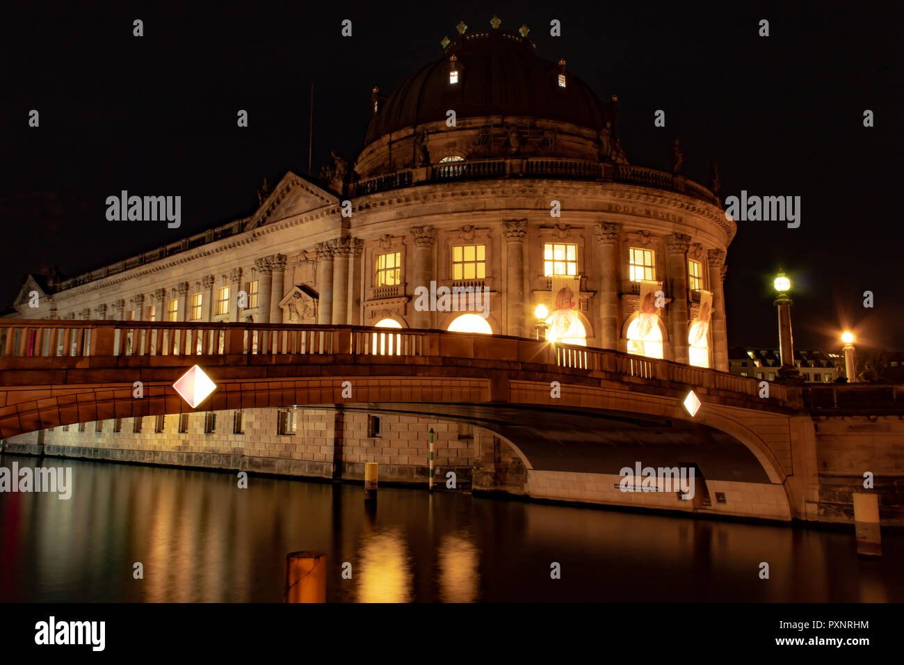 Berlin Bode Museum at Night  with bridge to Museums Island over the Spree River in the foreground in Berlin / Germany Stock Photo