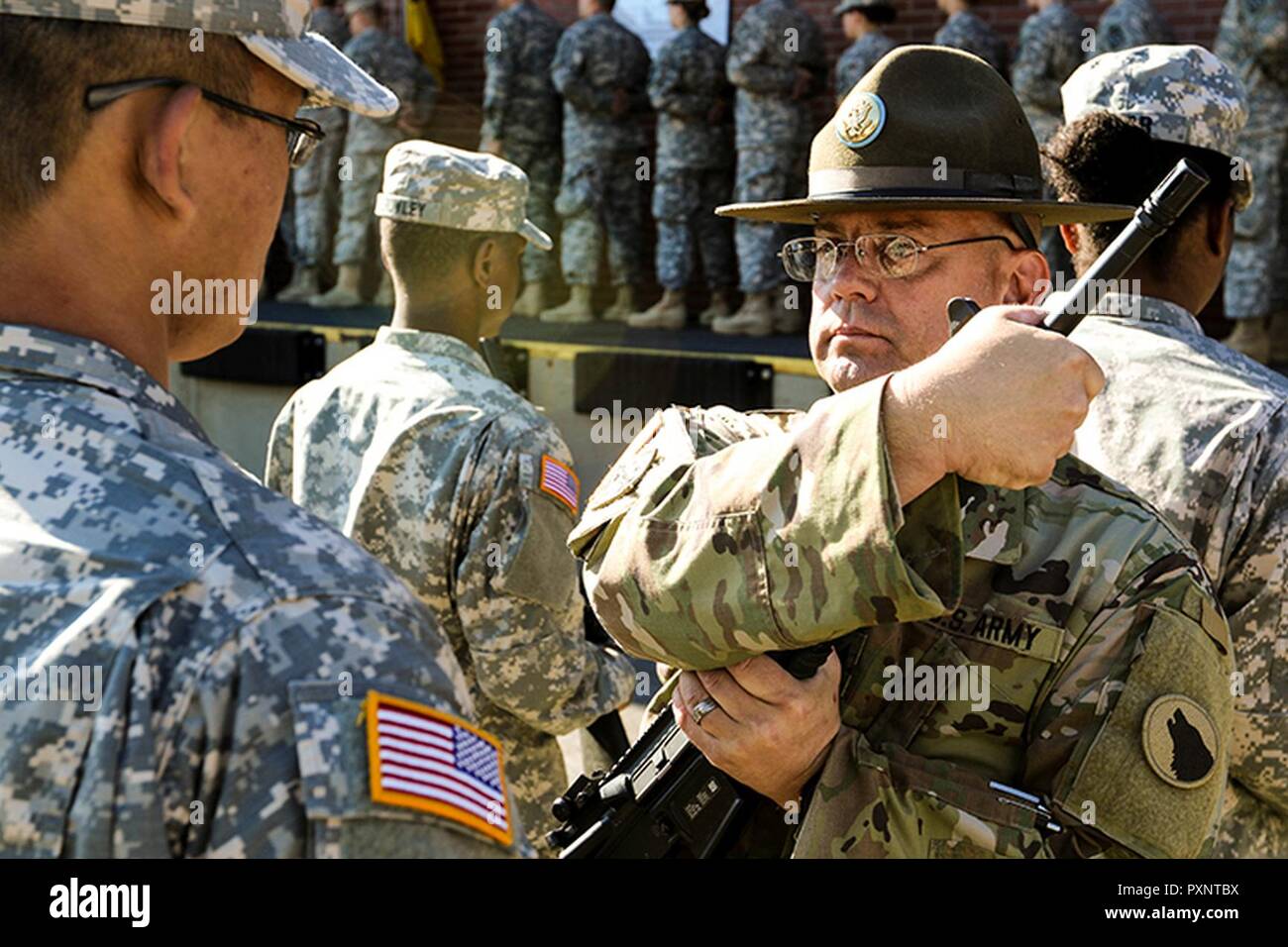 FORT KNOX, Kentucky –  Sgt. 1st Class James Smith, a U.S. Army Reserve drill sergeant assigned to Task Force Wolf, provides instruction to a Reserve Officers’ Training Corps (ROTC) cadet during Cadet Summer Training (CST) at Fort Knox, Kentucky, June 7, 2017.  As a civilian, Sgt. 1st Class Smith delivers mail for the U.S. Postal Service. Qualified and experienced Soldiers are in high demand for numerous training and support positions as the Army Reserve takes on a greater role in America’s highly sophisticated, full-spectrum fighting force. Stock Photo