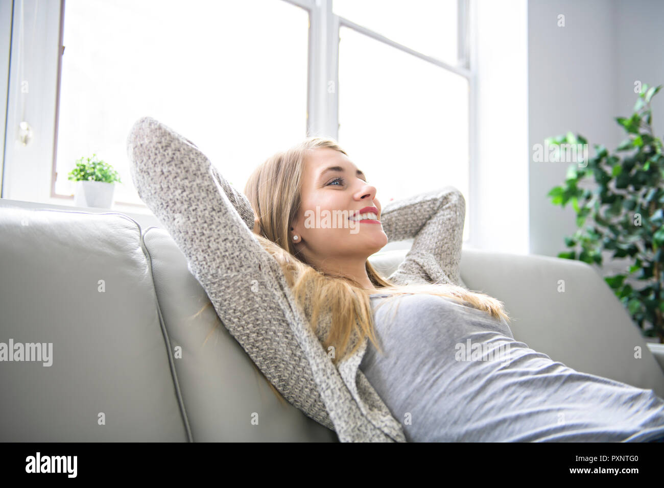 Woman on a sofa hi-res stock photography and images - Alamy
