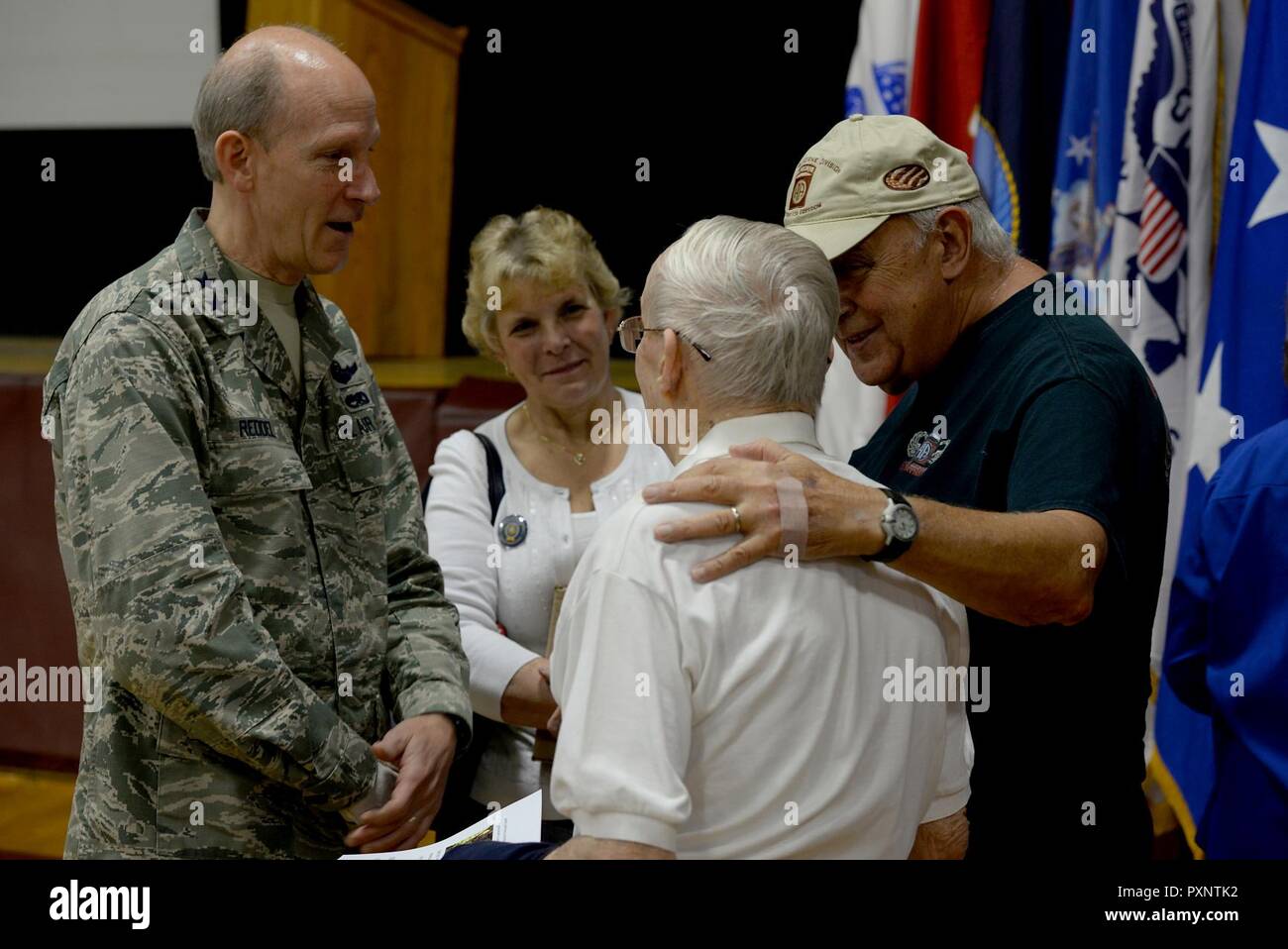 Maj. Gen. William Reddel III, the adjutant general of the New Hampshire National Guard, and his wife, Becky, speak with two veterans during the Vietnam Veterans Welcome Home Ceremony, at Alvirne High School in Hudson N.H., on June 17, 2017.  This was the fifth welcome home ceremony sponsored by the state of New Hampshire. Stock Photo