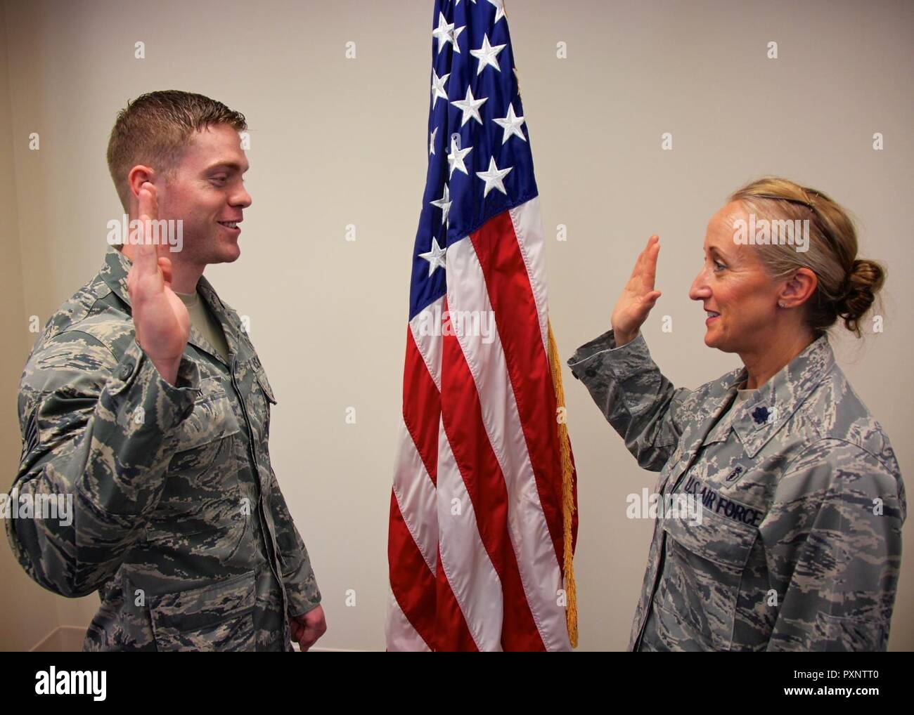 Staff Sgt. Brandon Issler takes the oath of enlistment again as administered by Lt. Col. Carole Lowe during the 932nd Airlift Wing drill held on June 4, 2017 at Scott Air Force Base, Illinois.  They are both members of the 932nd Aerospace Medicine Squadron.  AMDS keeps the unit humming medically with physicals and blood pressure checks, just a small part of the large amount of work that occurs to keep Airmen healthy and ready to deploy in the wing. Stock Photo