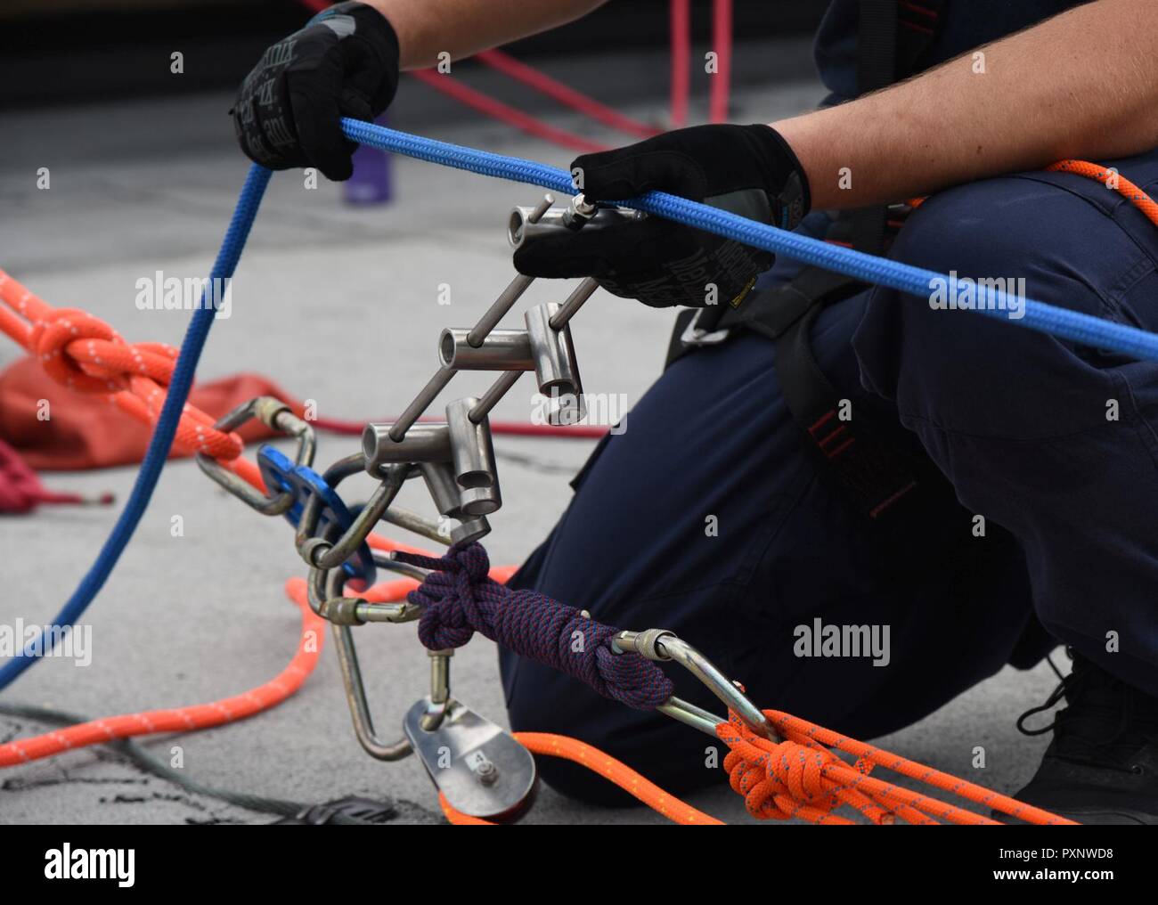 Taylor Beesley, Biloxi Firefighter, secures a rope for a