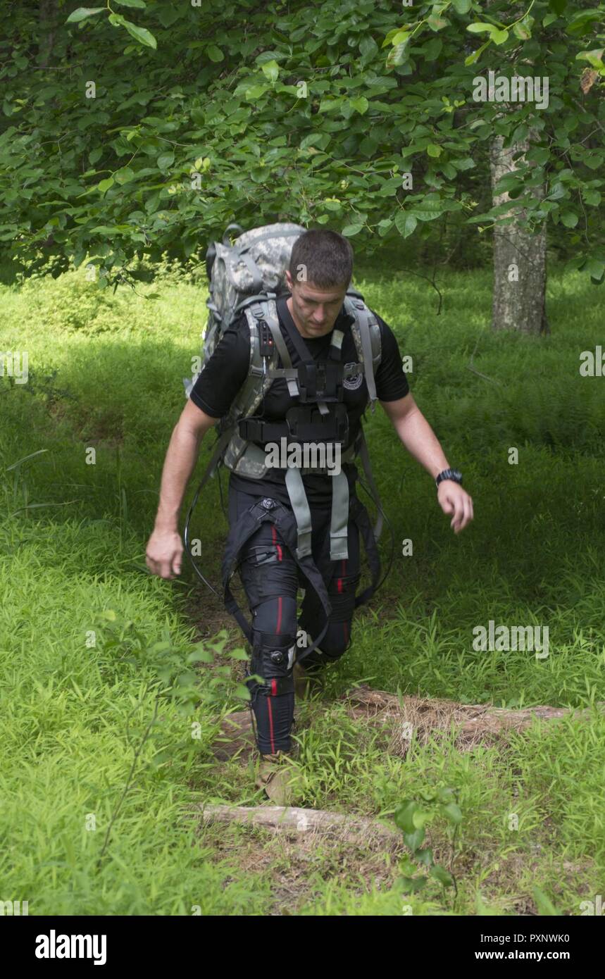 A Soldier wears an exosuit while on a three-mile outdoor course at a U.S. Army Research Laboratory facility at Aberdeen Proving Ground, Maryland. The suit, which is part of the Army's Warrior Web Program has pulleys and gears designed to prevent and reduce musculoskeletal injuries caused by dynamic events typically found in the warfighter's environment. Stock Photo