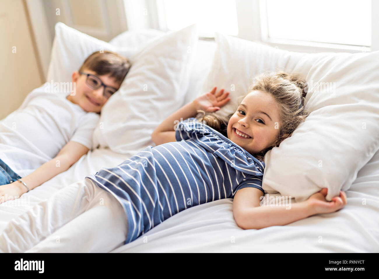 Brother And Sister having fun Together on Bed Stock Photo Alamy