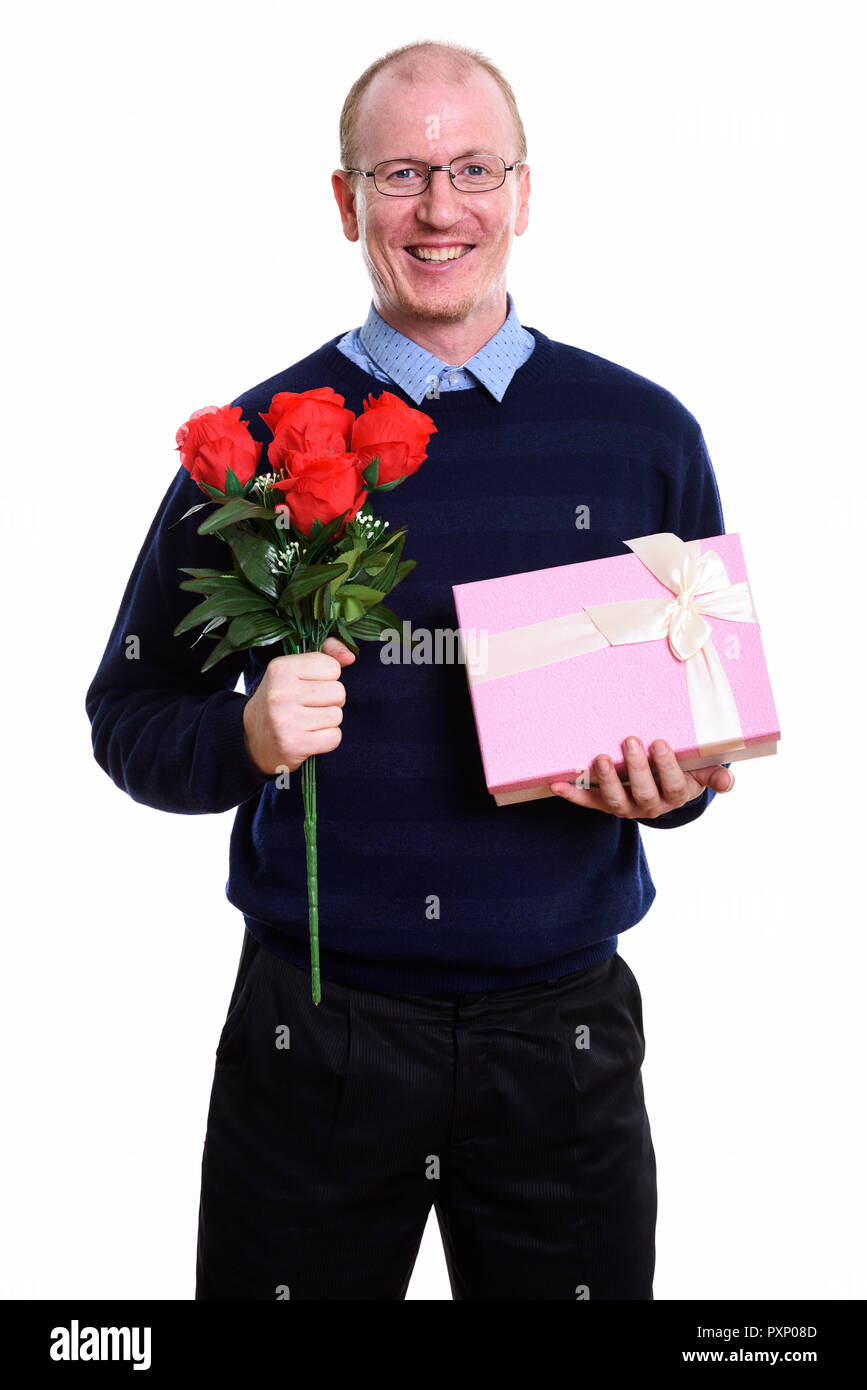 Studio shot of happy man smiling while holding red roses and gif Stock Photo