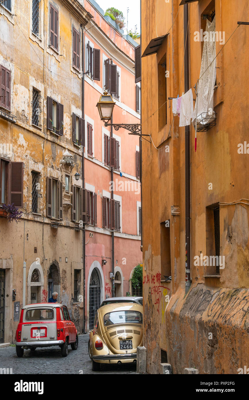 Old cars and colourful old houses in the Trastevere district of Rome, central Italy. Stock Photo