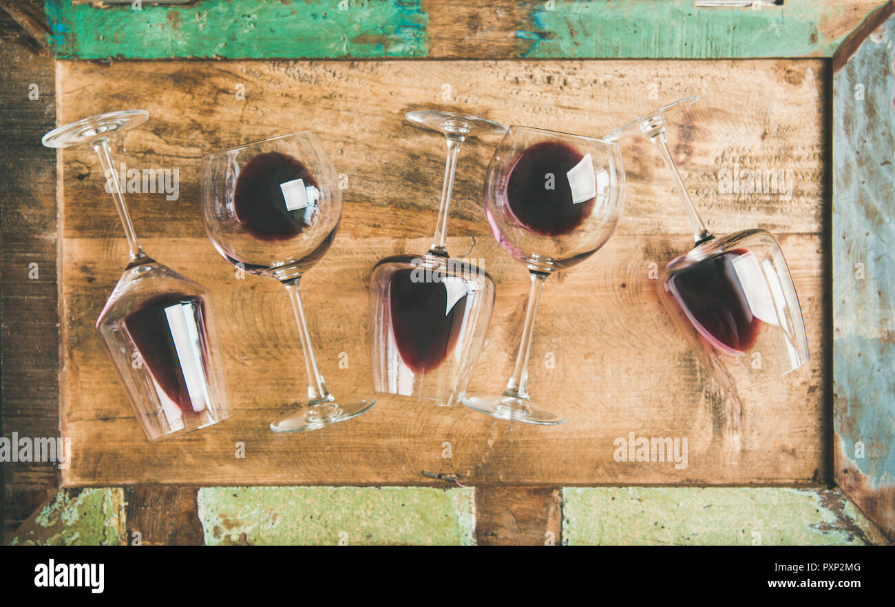Red wine in glasses over rustic wooden tray background Stock Photo