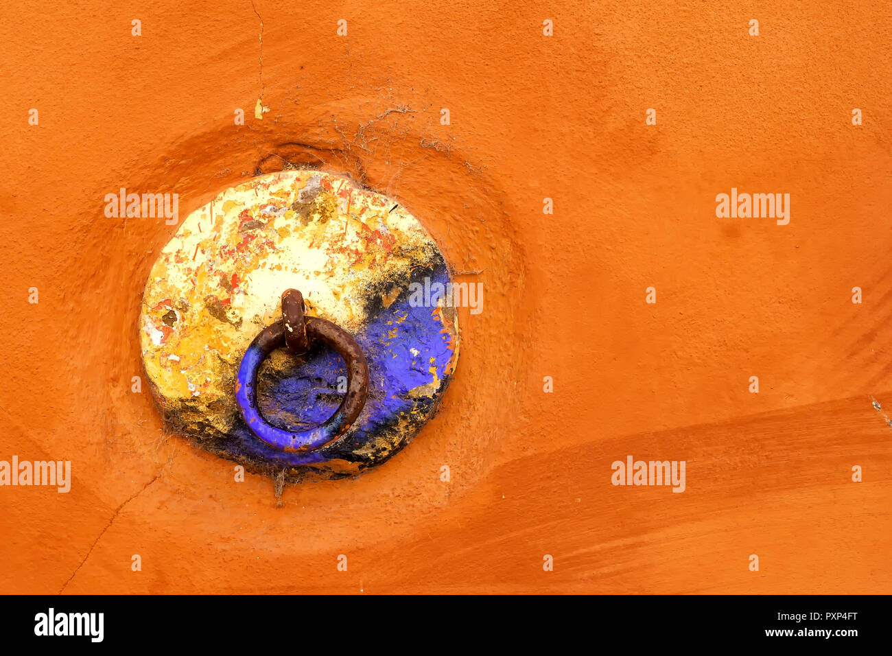 Doorknob painted by many colors. Base in bright orange. Downtown of