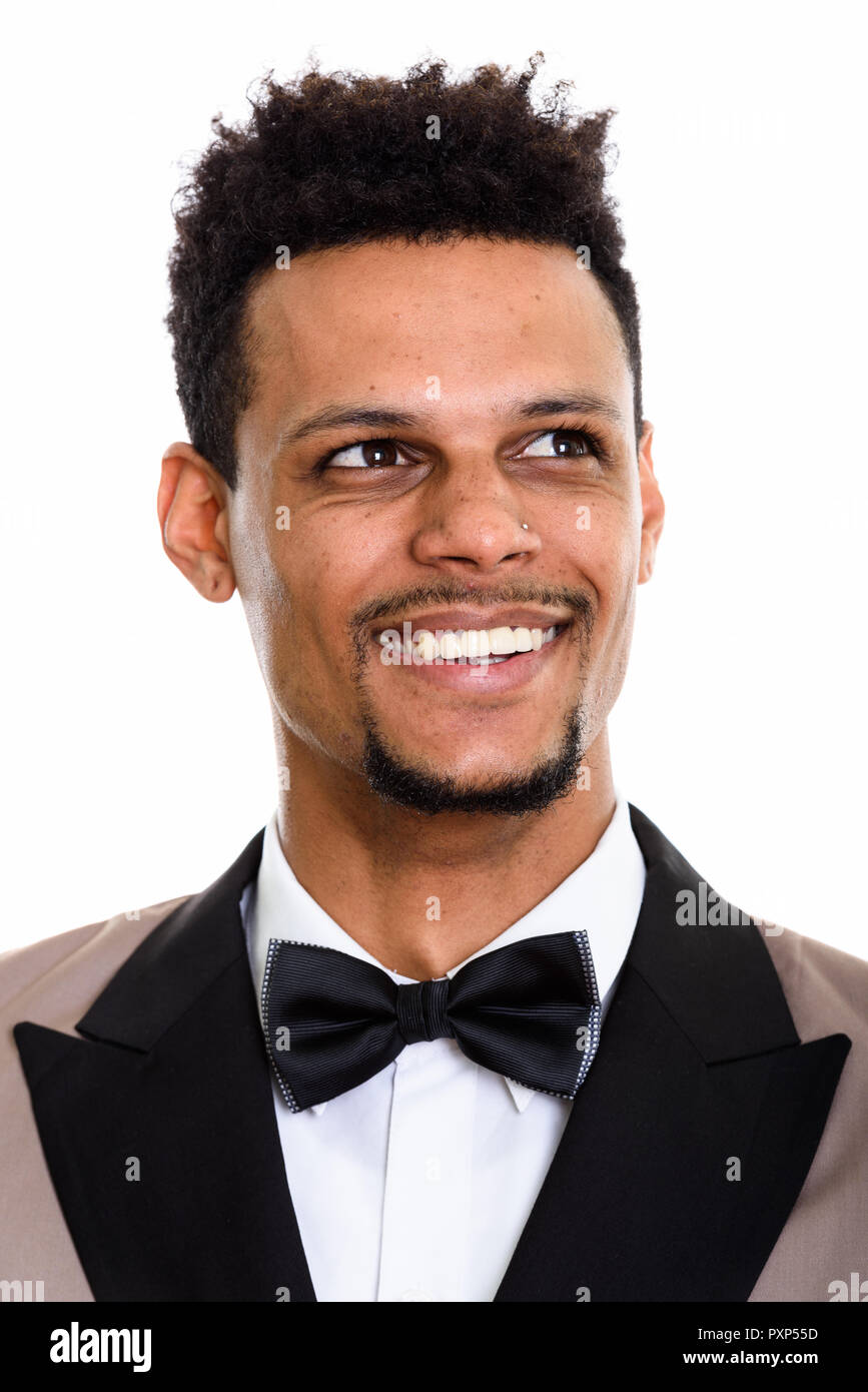 Face of young happy African businessman smiling while thinking Stock ...