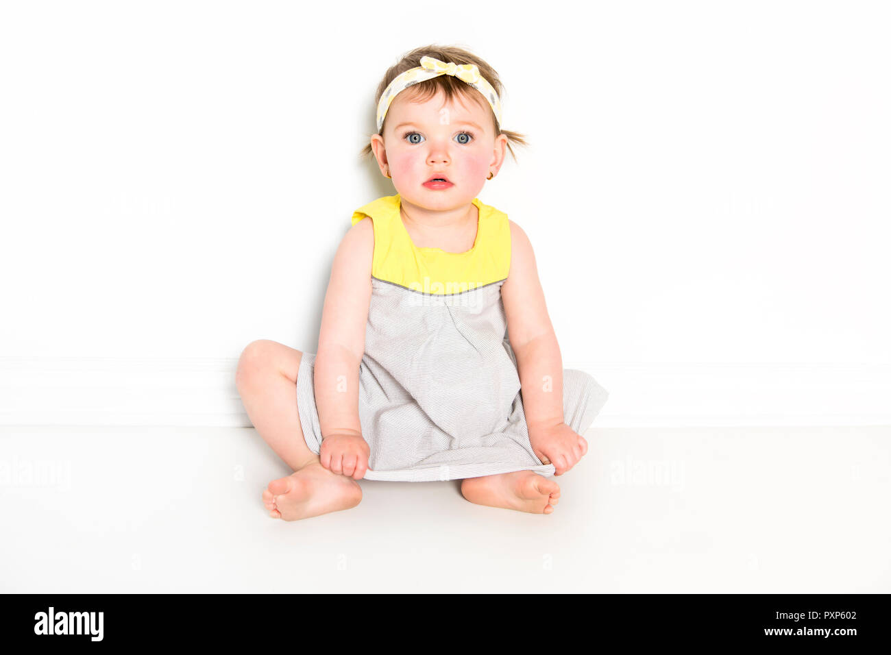 Portrait of a young girl in yellow on photo studio Stock Photo - Alamy
