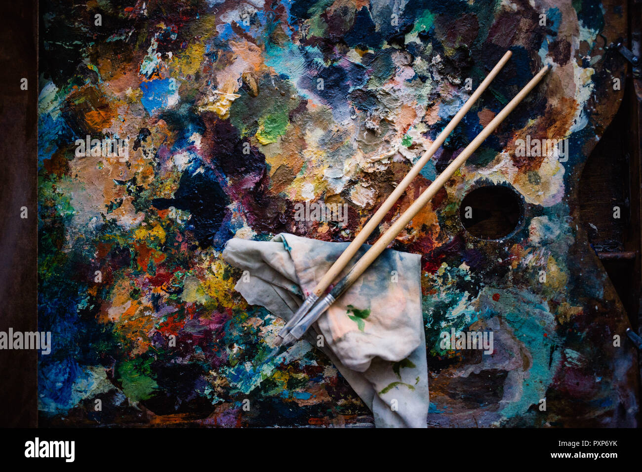 A Real Artist S Palette Oil Paints And Two Paint Brushes Stock
