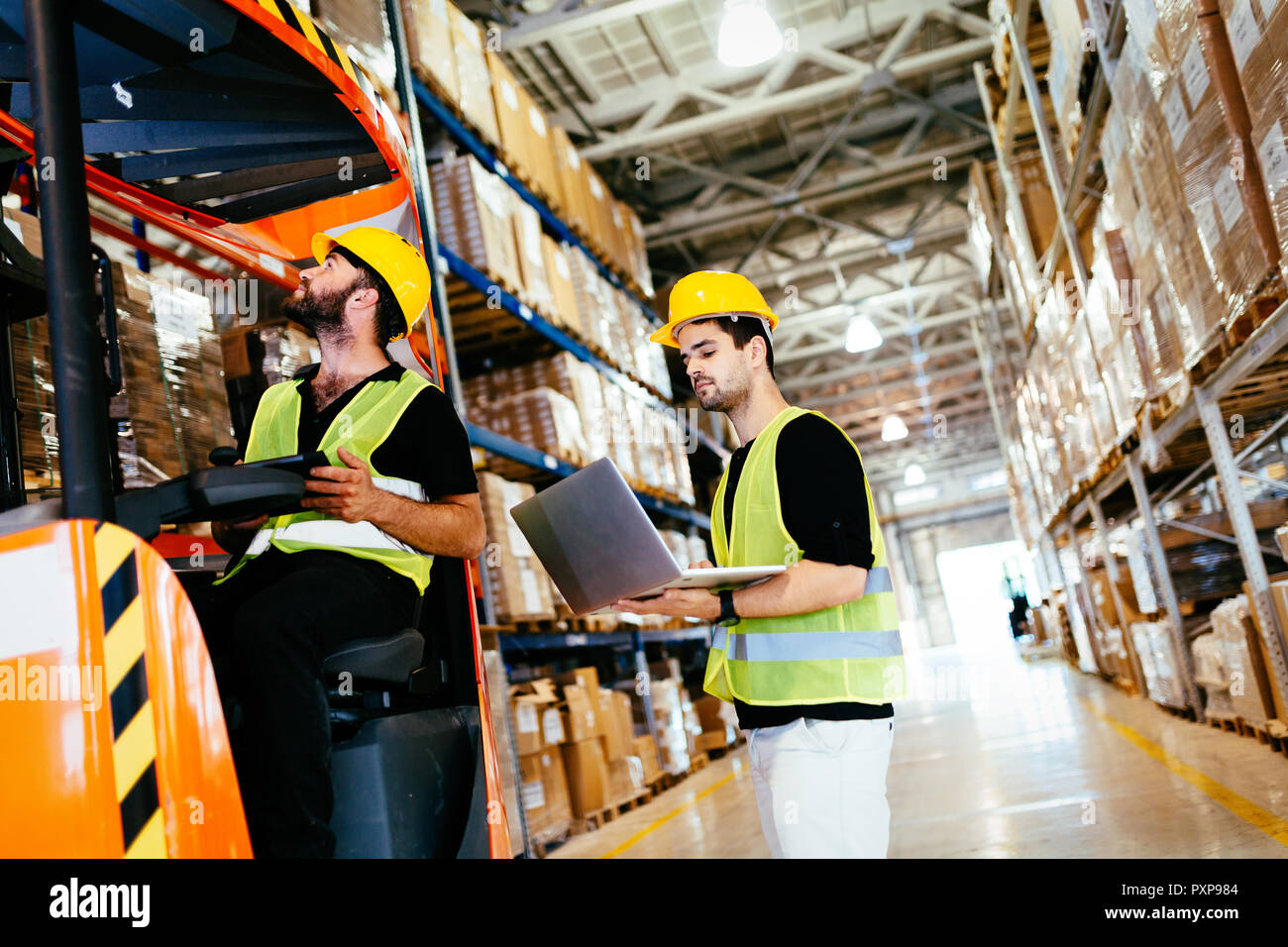 Warehouse Workers Working Together With Forklift Loader Stock Photo Alamy