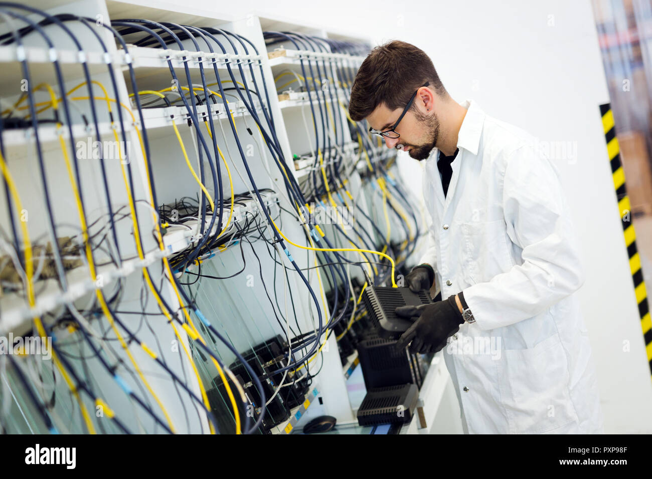 Picture of network technician testing modems in factory Stock Photo Alamy