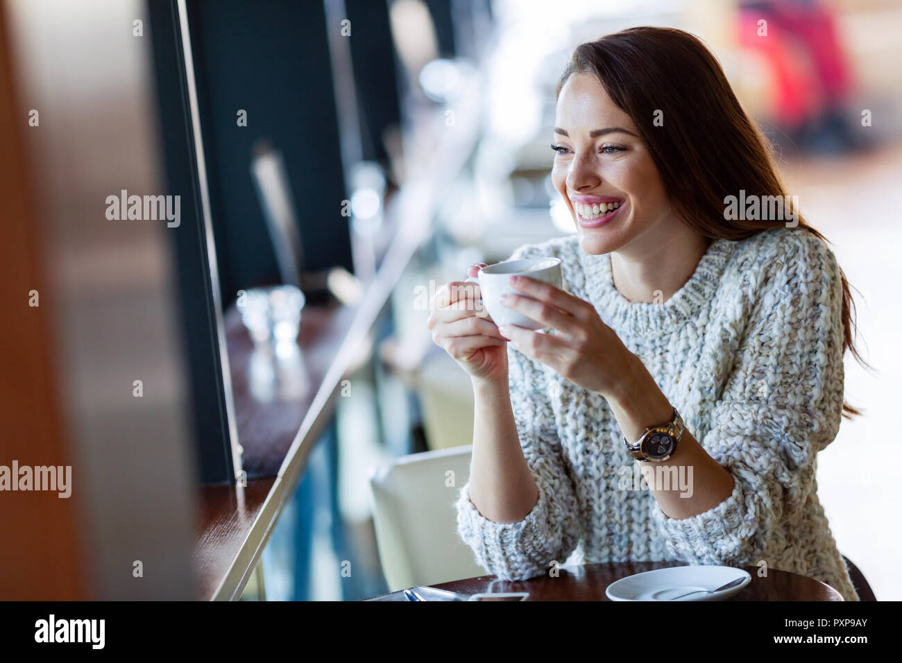 https://c8.alamy.com/comp/PXP9AY/young-beautiful-woman-drinking-coffee-in-restaurant-PXP9AY.jpg