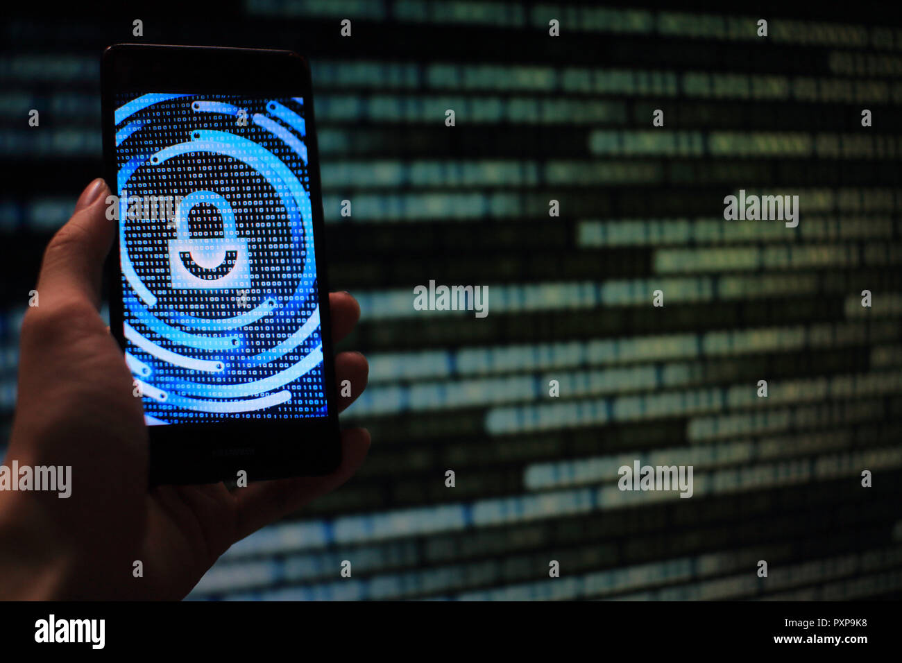 hand hold mobile phone flow. padlock icon symbolize security and motion movement of blue binary code computer data moving in the background. Stock Photo