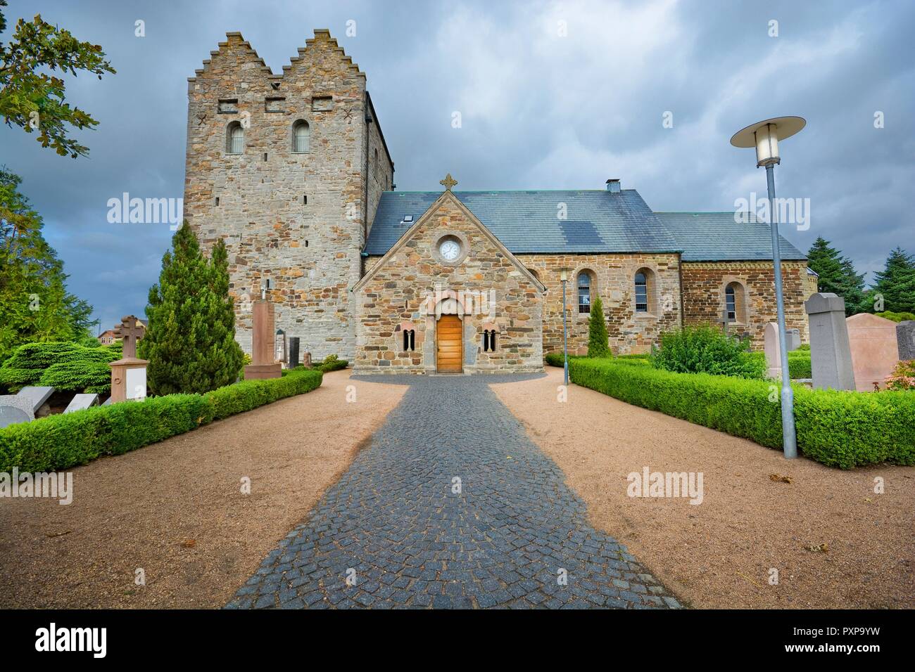 Aa church against cloudy sky in Aakirkeby, Denmark. It is the and oldest church on the Bornholm island, constructed from greensand stone, domi Stock Photo - Alamy