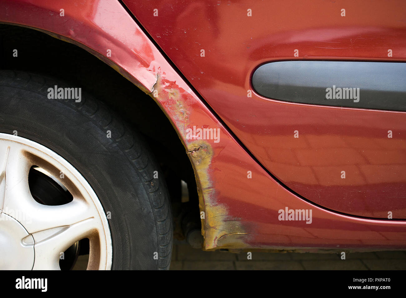 Rust is eating away vehicles' wheel arch, problem in older cars Stock Photo