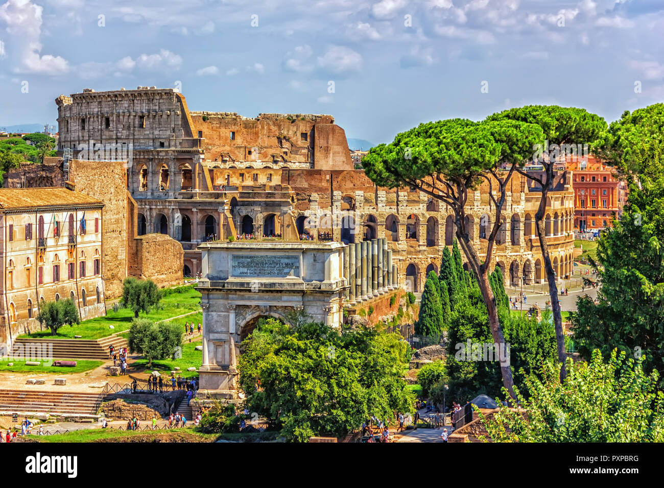 View from the Roman Forum on the Arch of Titus and the Colosseum, summer cloudy day Stock Photo