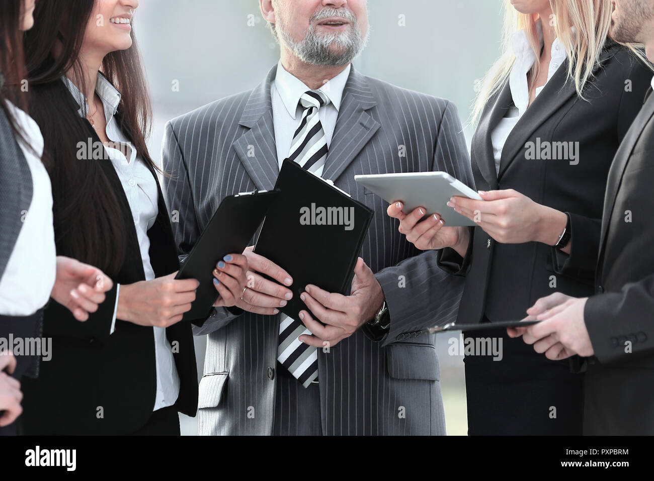 close up.a business team standing talking in the office Stock Photo - Alamy
