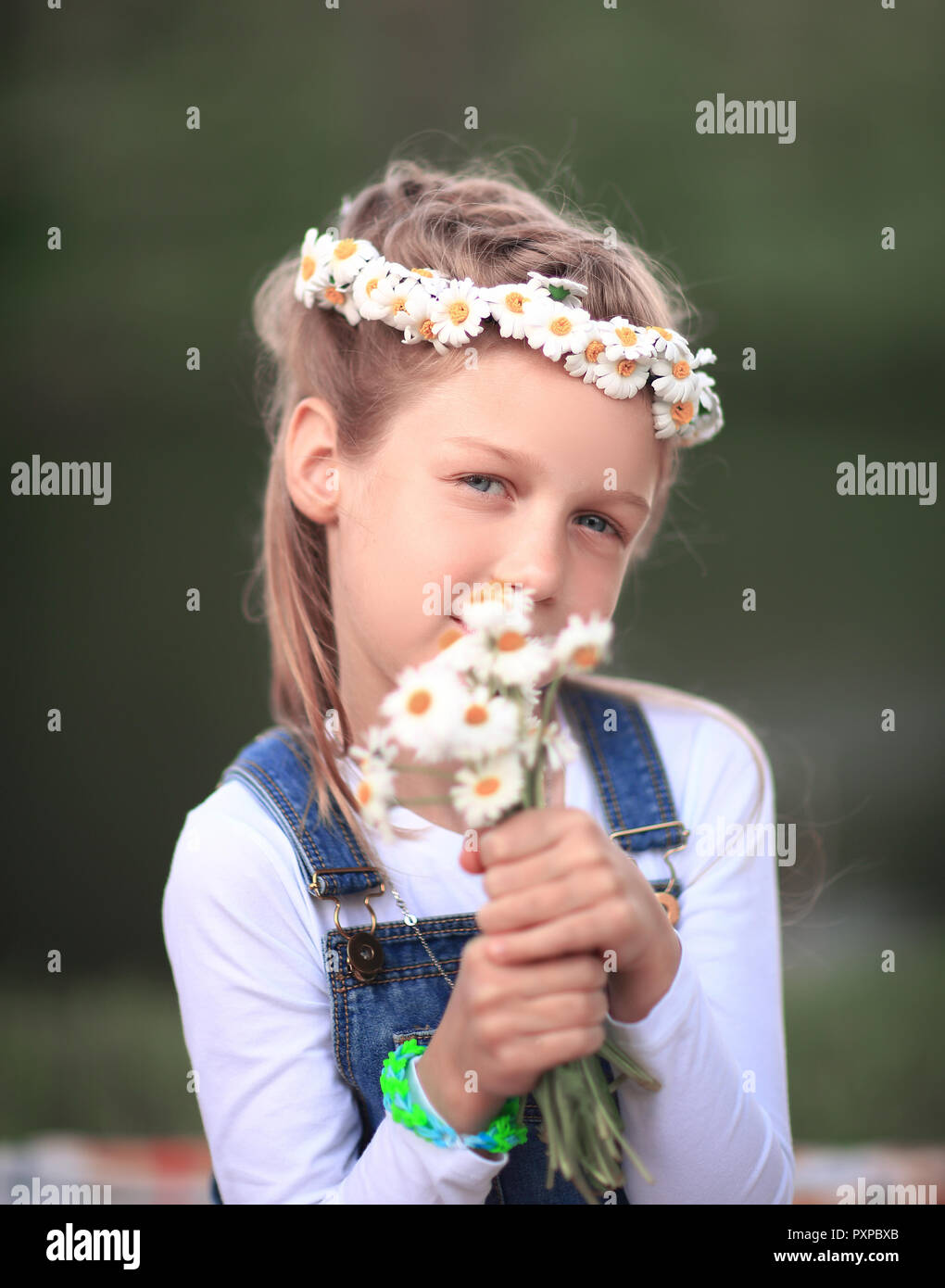 portrait of cute little girl in a wreath and a bouquet of wild f Stock ...