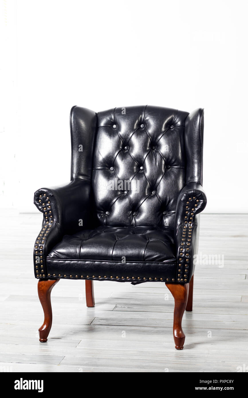 The Old Antique Black Leather Wing Arm Chair Stock Photo Alamy