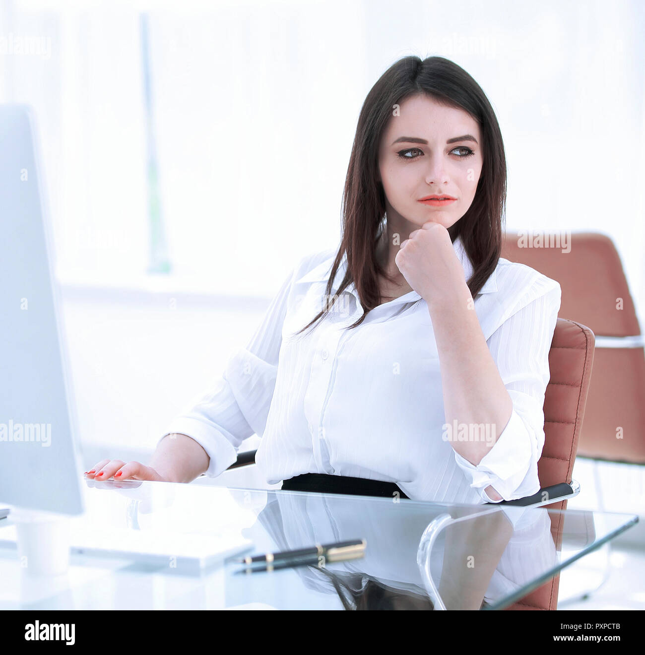 serious business woman sitting at the Desk in the office Stock Photo ...