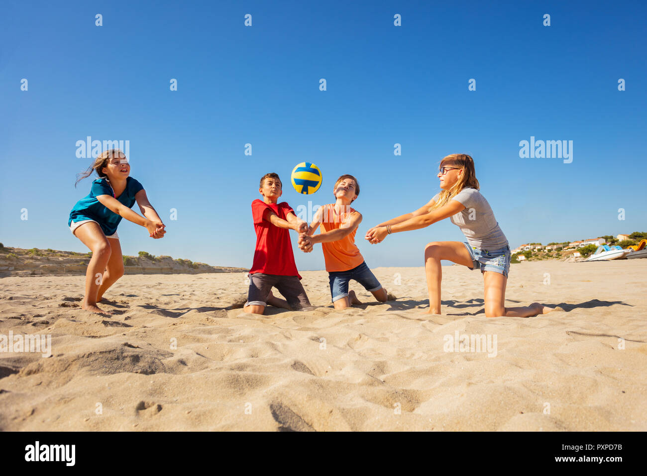 Teenage boys and girls, young volleyball players, making a forearm pass