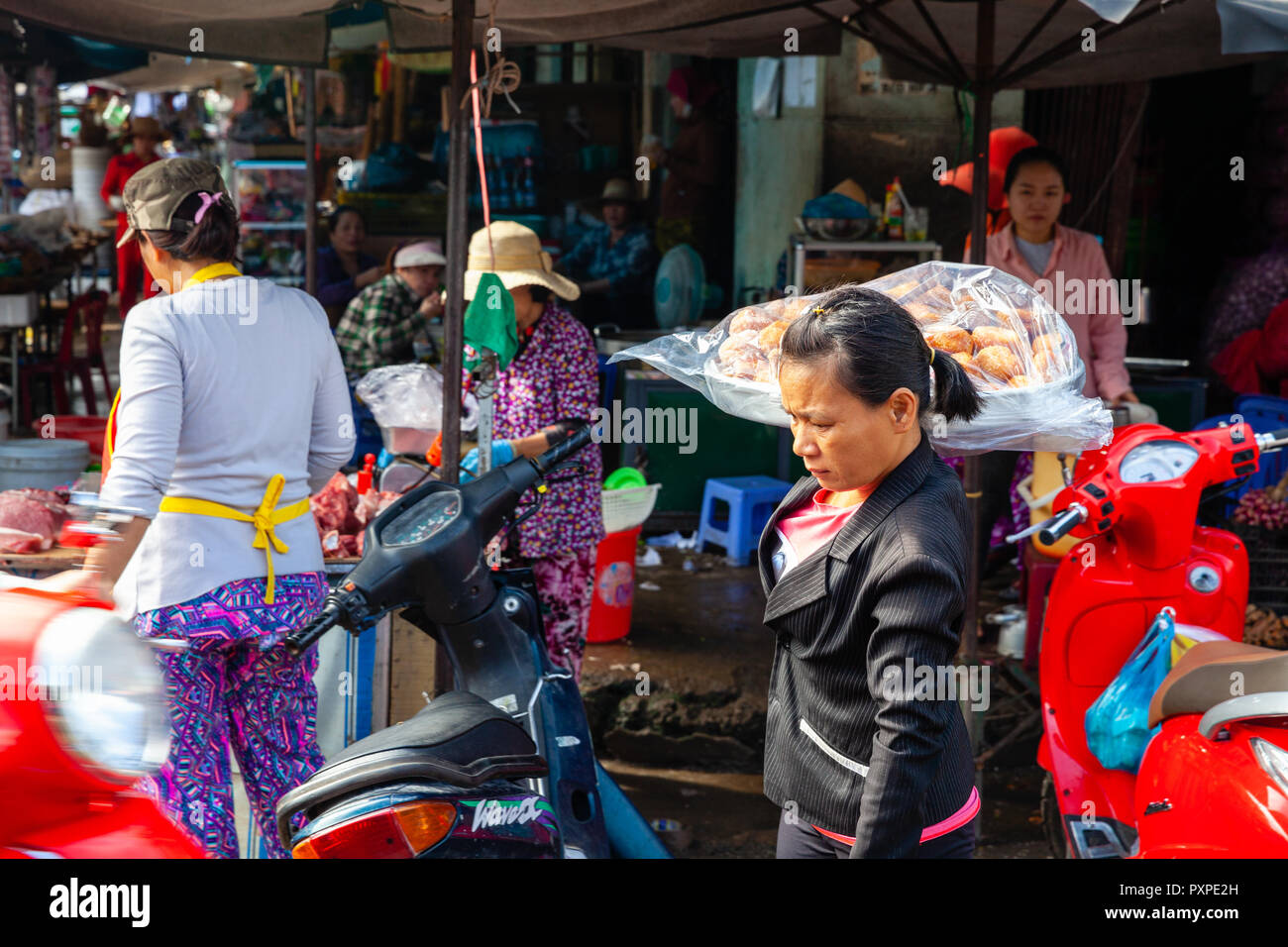 NHA TRANG, VIETNAM - SEPTEMBER 12: A Vietnamese woman sells donuts on the street market on September 12, 2018 in Nha Trang, Vietnam. Stock Photo