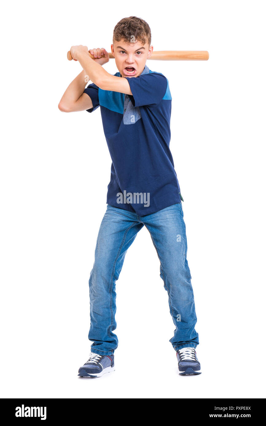 Full length portrait of young caucasian teen boy holding a baseball bat and screaming. Funny teenager hooligan looking at camera, isolated on white ba Stock Photo
