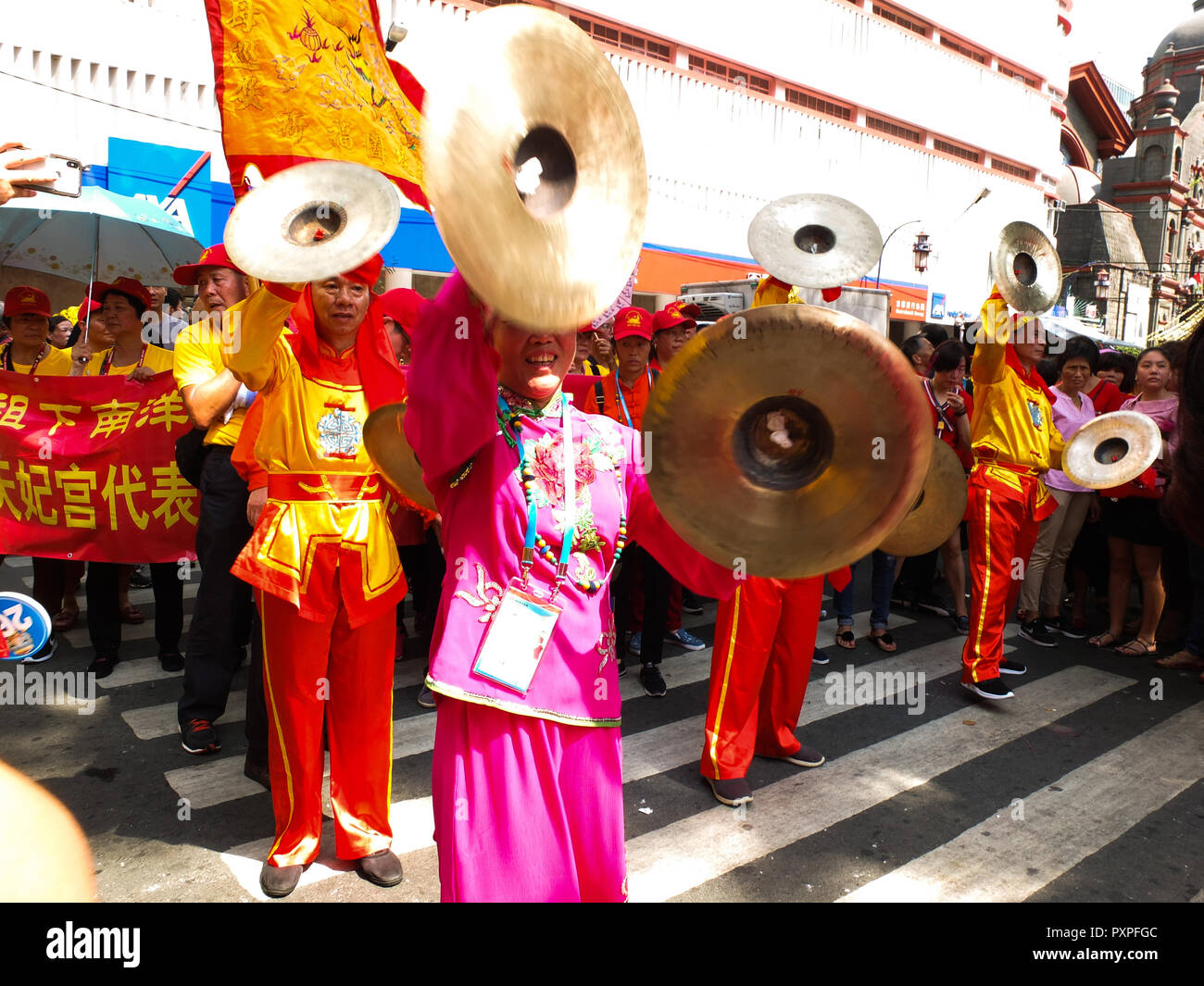 Chinese performers are seen with their musical instrument, the cymbal