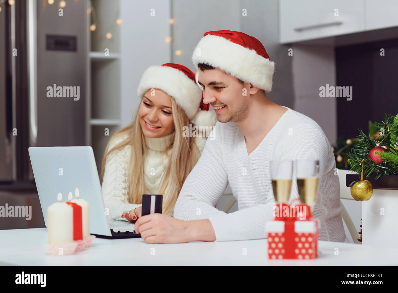 A couple shopping on the internet at home for Christmas Stock Photo