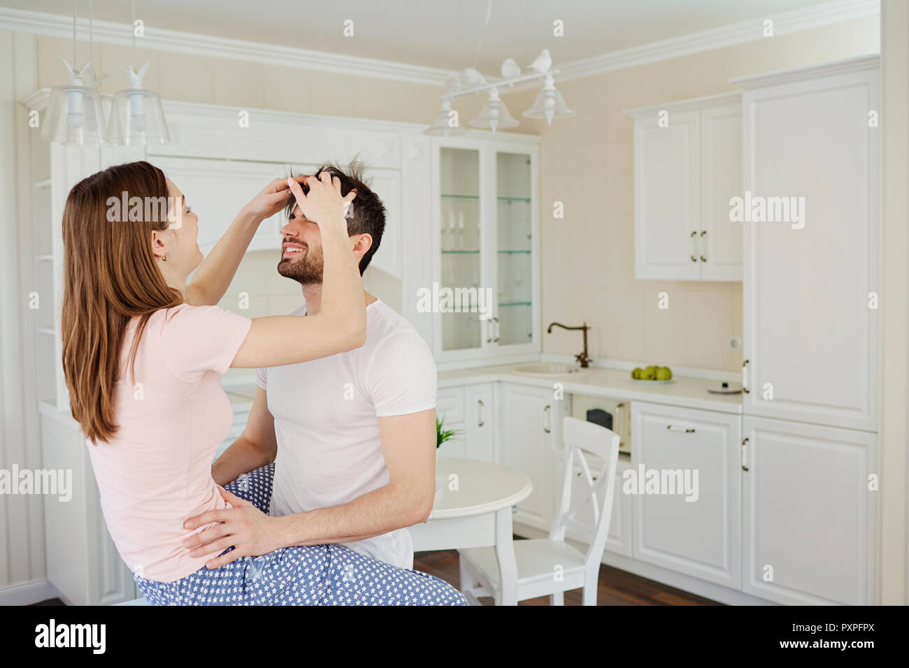 Young couple having fun in the kitchen. Stock Photo