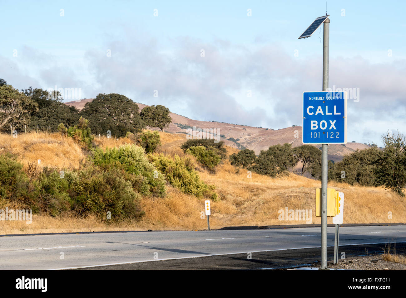 A highway call box along a rural roadside serves to help drivers in an