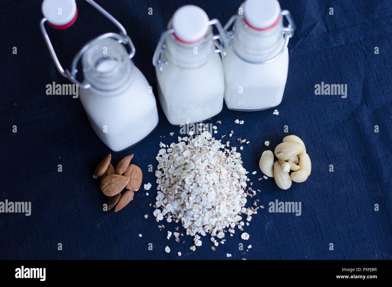 A group of non-dairy alternatives on a dark background. Stock Photo