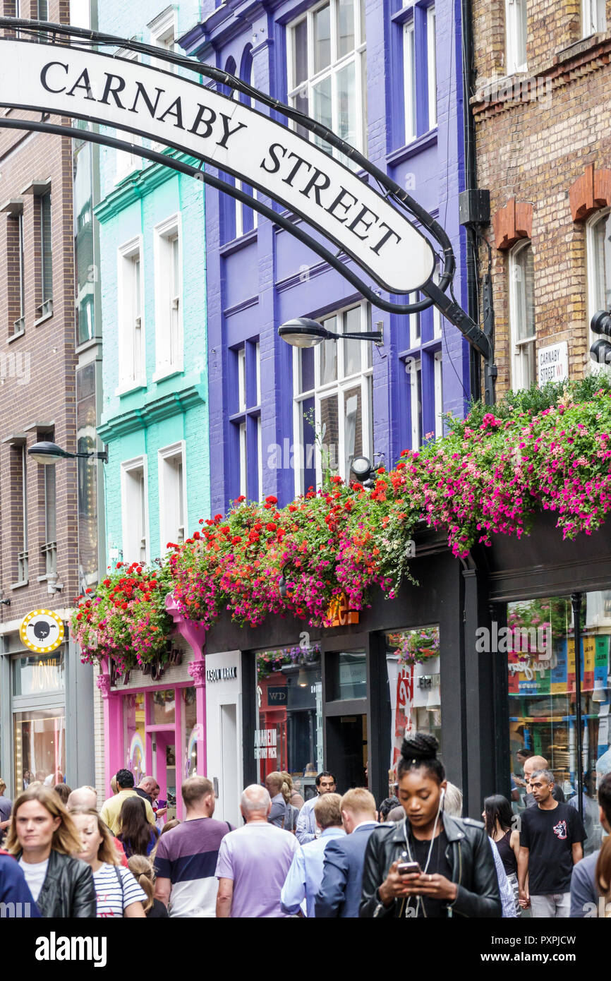 London England,UK,Soho Carnaby Street,pedestrian-only shopping street,flower planters,crowd,man men male,woman female women,UK GB English Europe,UK180 Stock Photo