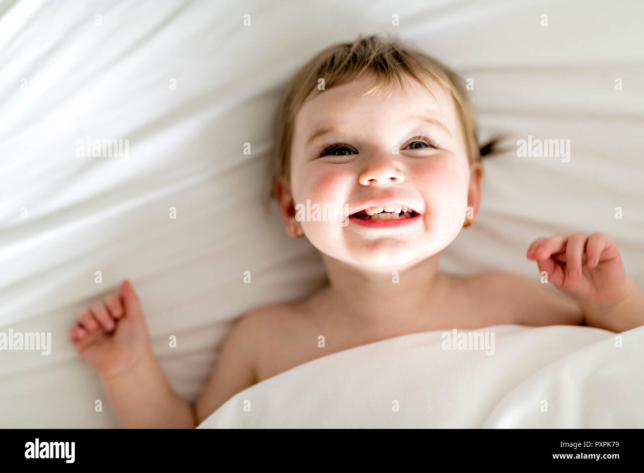 one years girl baby on the bed Stock Photo Alamy
