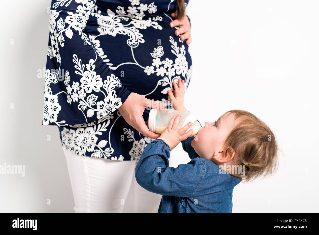 Portrait of a pregnant woman with baby child drink milk bottle Stock Photo